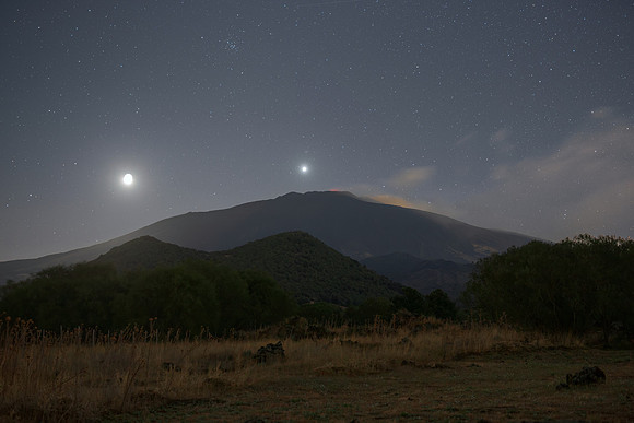 Earthshine Moon Venus and M44 Alignment Above Mount Etna