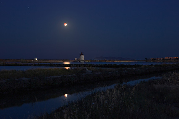 Double Lunar Eclipse Above The Salt Ponds Of Trapani Sicily