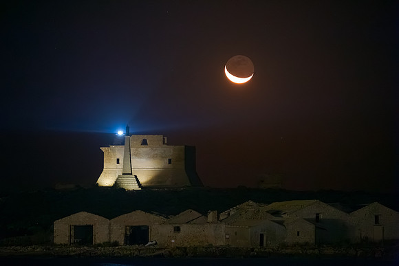 Sickle Moon Rising Above The Lighthouse of Portopalo